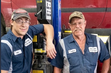 Auto mechanic inspecting a vehicle in the shop